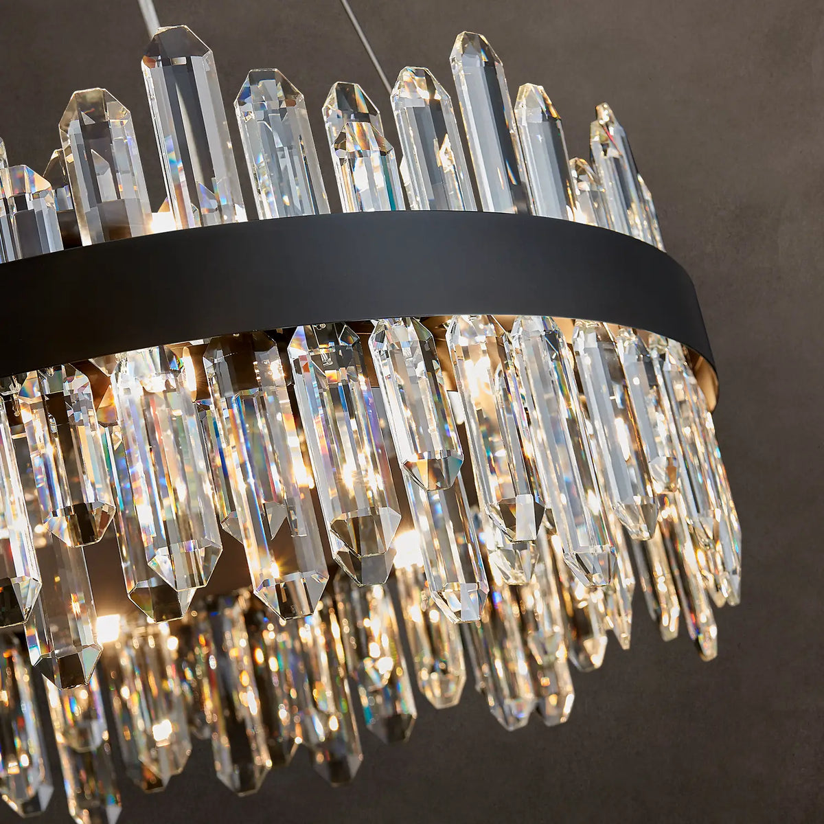 Close-up of black frame and K9 crystal prisms on round chandelier