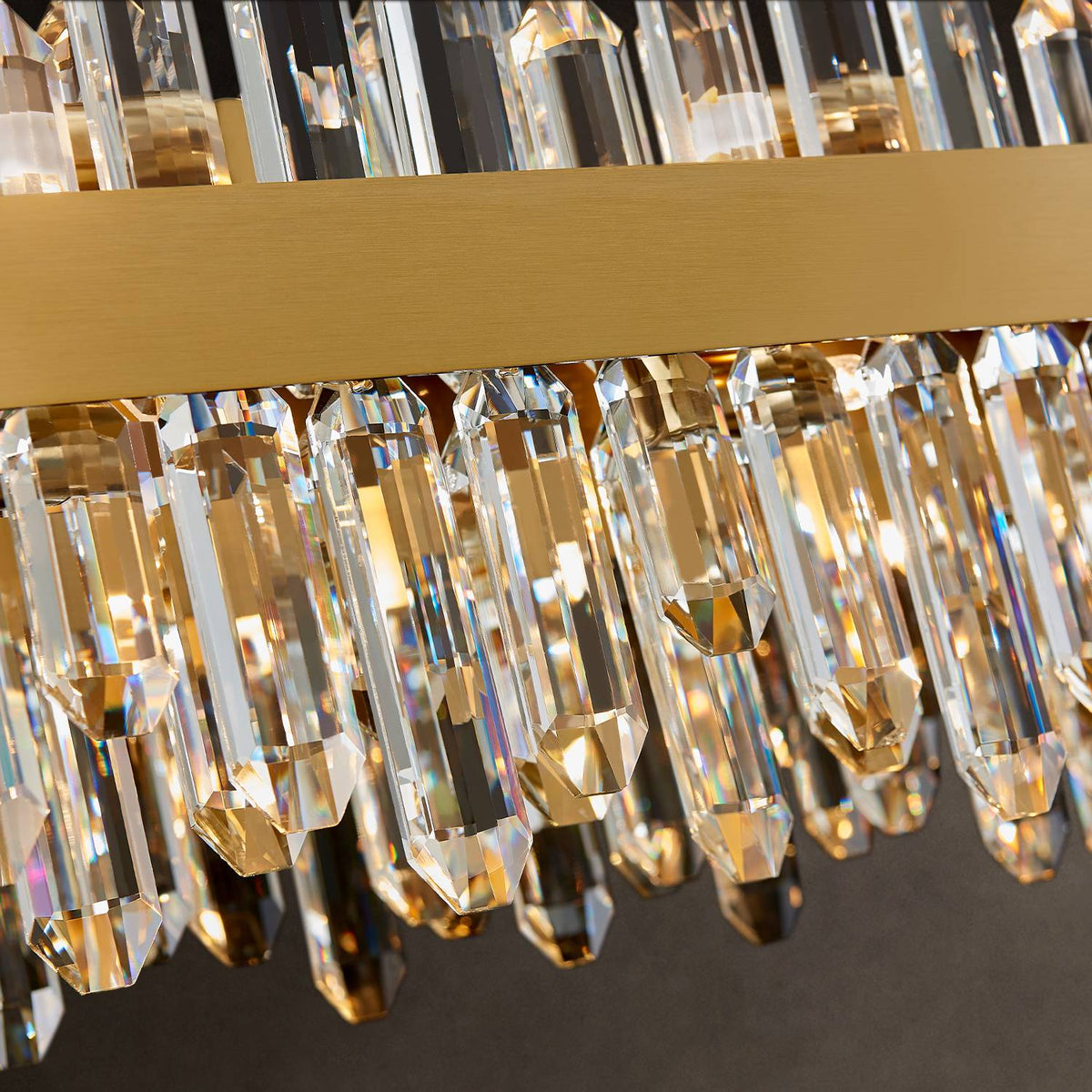 Close-up of gold frame and K9 crystal prisms on rectangular chandelier